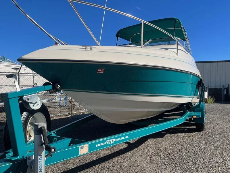 Slide: The Image of 1995 Regal Valanti 222 boat on trailer, teal and white, parked outdoors. - 5