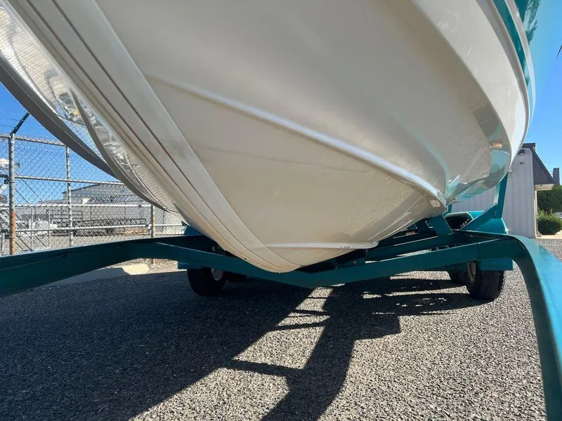 Slide: The Image of 1995 Regal Valanti 222 boat on trailer, close-up view of hull and trailer. - 9