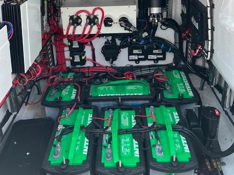 Slide: The Image of Battery compartment of 2021 ZCB 2600 Freemason CC with multiple green batteries and wiring. - 12