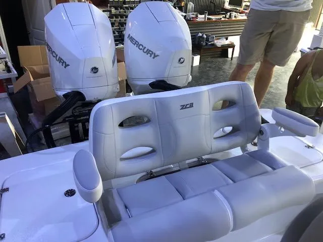 Slide: The Image of 2021 ZCB 2600 Freemason CC boat with dual Mercury engines and cushioned seating. - 4