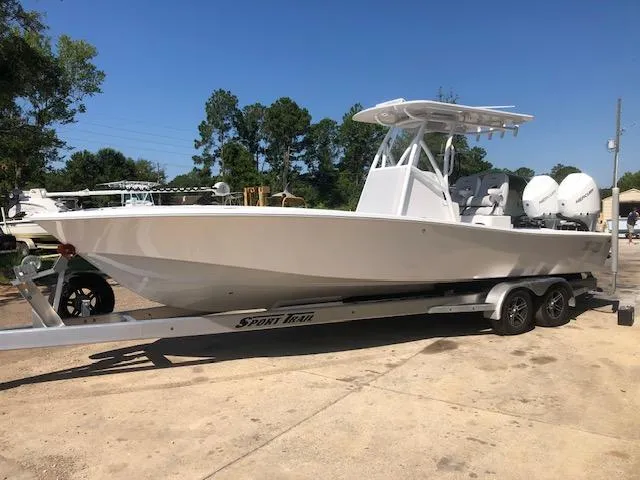 Slide: The Image of 2021 ZCB 2600 Freemason CC boat on trailer, parked outdoors. - 6