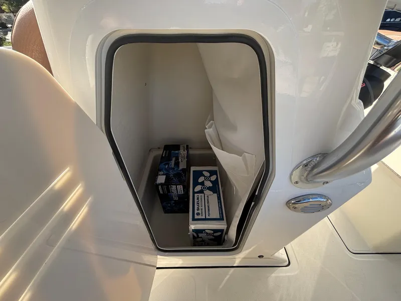 Slide: The Image of Storage compartment on 2025 Pioneer 202 Sportfish boat with items inside. - 11