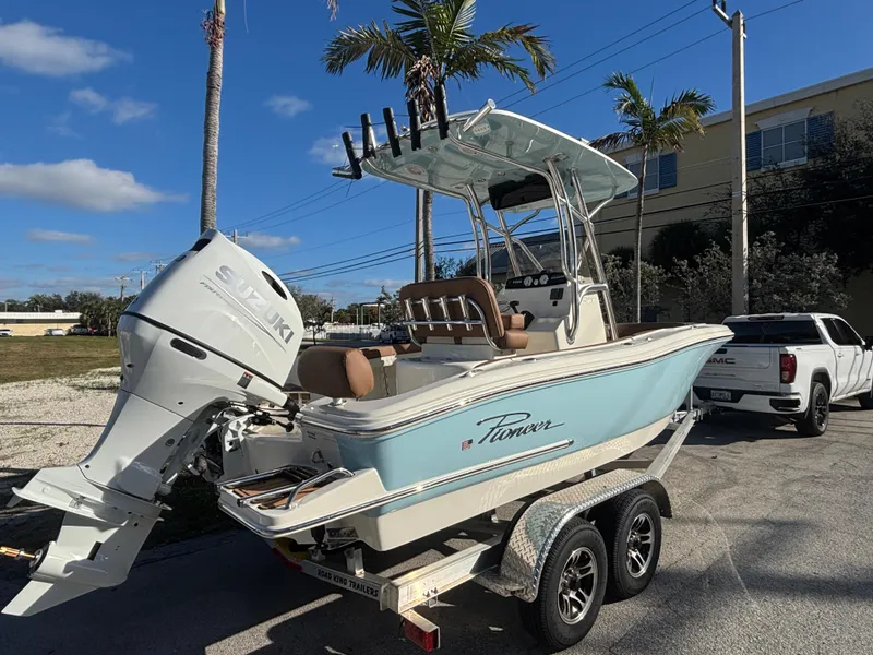 Slide: The Image of 2025 Pioneer 202 Sportfish boat on trailer, parked outdoors under clear sky. - 4