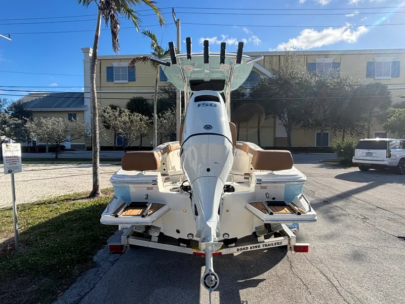 Slide: The Image of 2025 Pioneer 202 Sportfish boat on trailer, parked outdoors under clear sky. - 5