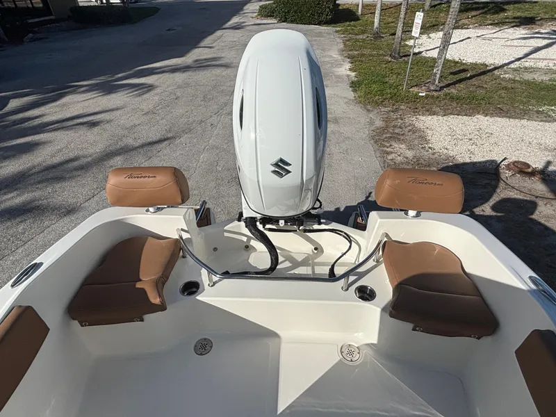 Slide: The Image of 2025 Pioneer 202 Sportfish boat with Suzuki outboard motor and tan seating. - 7