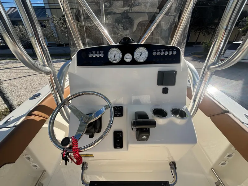 Slide: The Image of 2025 Pioneer 202 Sportfish boat console with steering wheel and gauges. - 9
