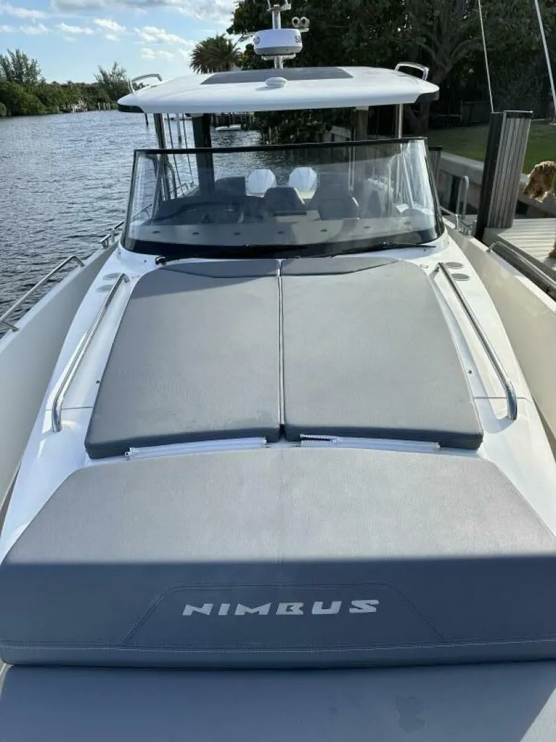 Slide: The Image of Nimbus T-11 2022 boat docked by a scenic river. - 10