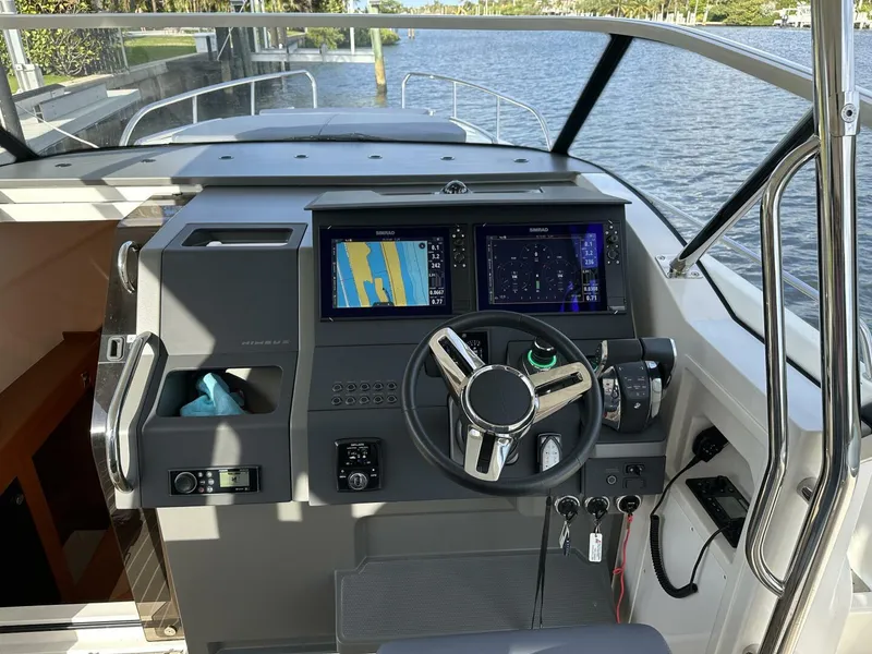 Slide: The Image of Nimbus T-11 2022 boat cockpit with advanced navigation system and steering wheel. - 13