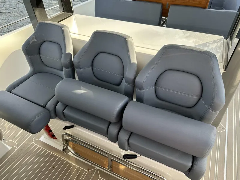 Slide: The Image of Three luxurious gray seats on a 2022 Nimbus T-11 boat. - 16