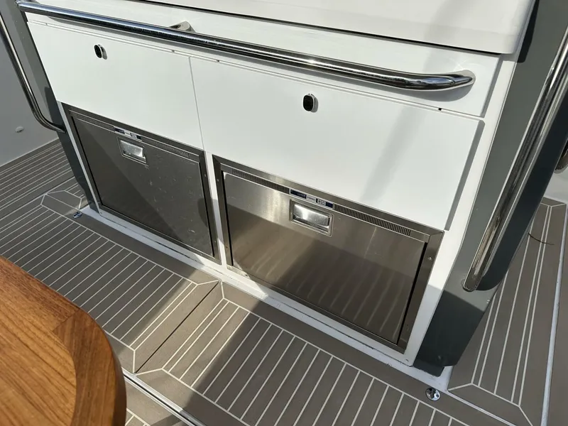 Slide: The Image of Nimbus T-11 2022 boat interior with dual stainless steel storage compartments. - 18