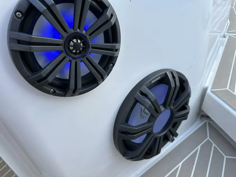 Slide: The Image of Close-up of two black speakers with blue LED lights on a Nimbus T-11, 2022 model. - 22