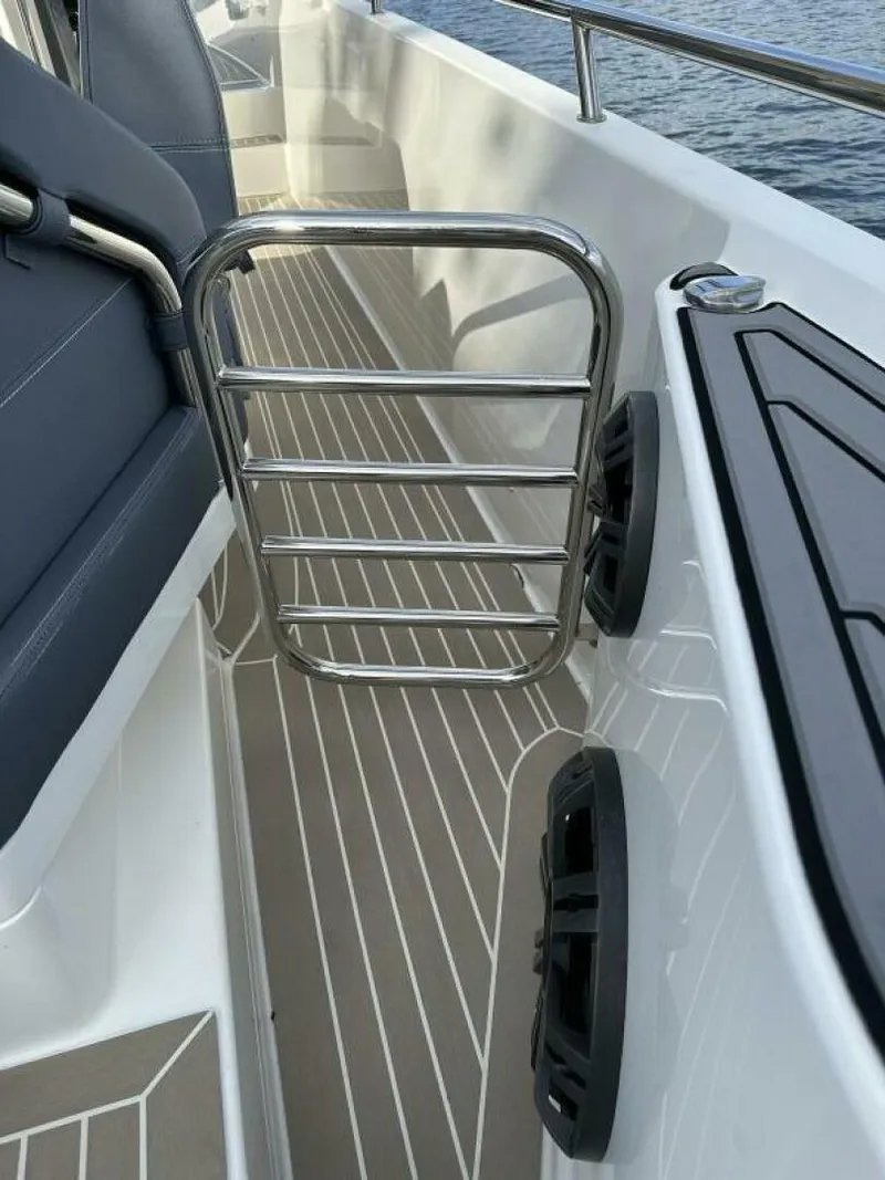 Slide: The Image of Nimbus T-11 2022 boat interior with metal railing and speakers. - 23