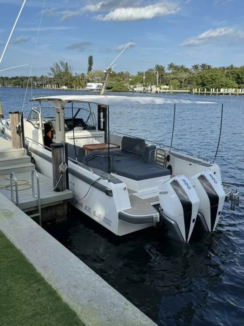 Slide: The Image of 2022 Nimbus T-11 boat docked by a scenic waterfront. - 3