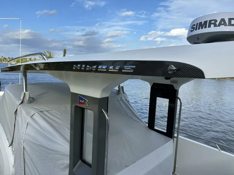 Slide: The Image of Nimbus T-11 boat, 2022 model, with sleek design and Simrad equipment, on a calm water backdrop. - 6
