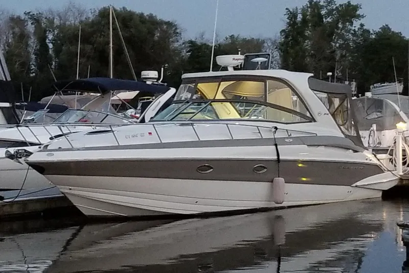 Slide: The Image of 2007 Crownline 340 CR boat docked at marina, evening view. - 0