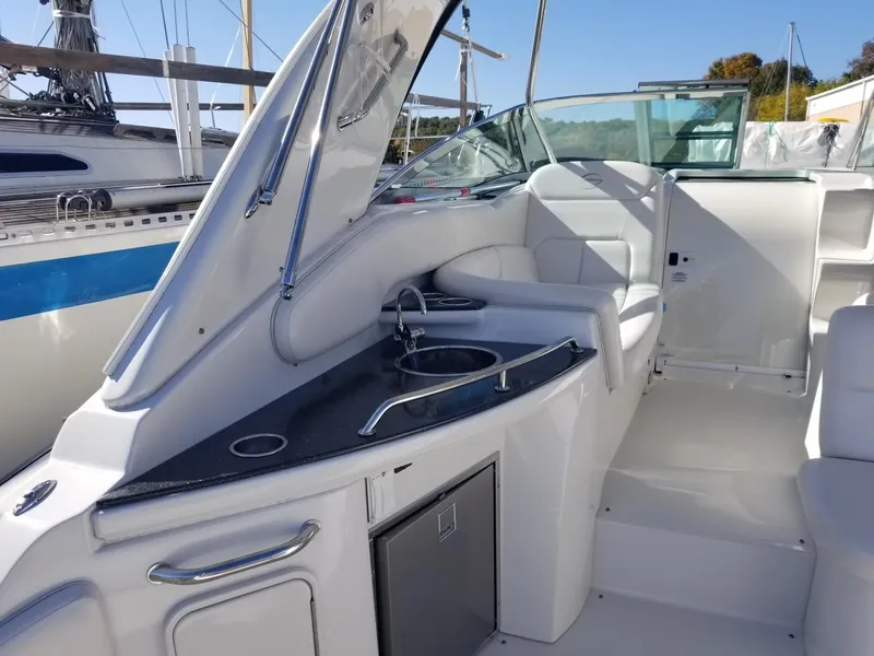 Slide: The Image of 2007 Crownline 340 CR boat interior with seating and kitchenette area. - 10