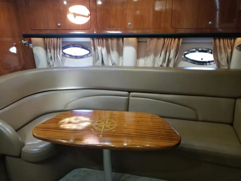 Slide: The Image of Luxurious 2007 Crownline 340 CR yacht interior with elegant wood table and plush seating. - 17