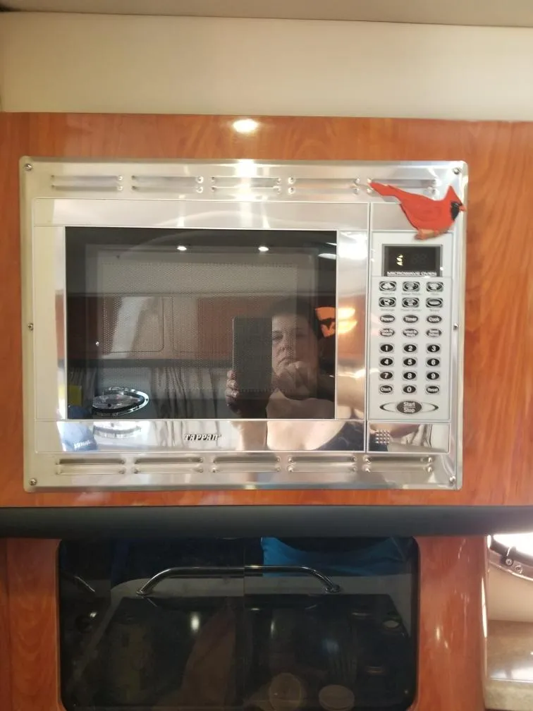 Slide: The Image of Microwave in 2007 Crownline 340 CR boat interior with wood paneling. - 20