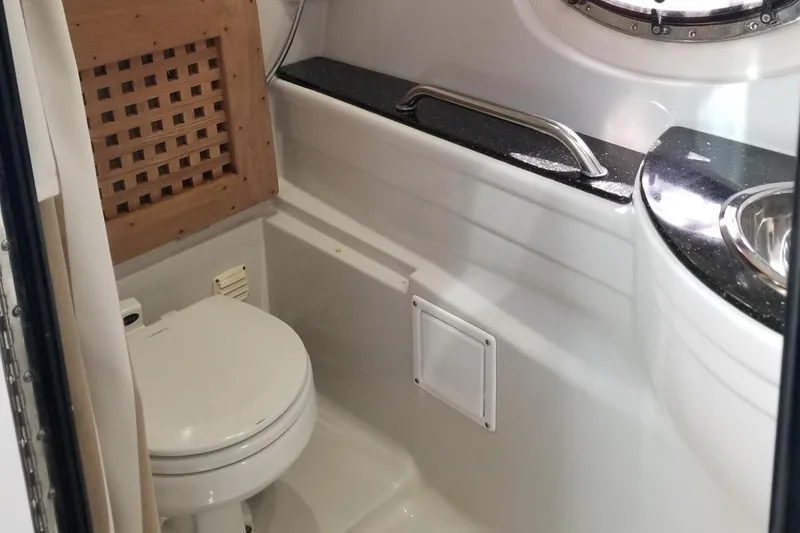 Slide: The Image of 2007 Crownline 340 CR boat bathroom with toilet and sink. - 22