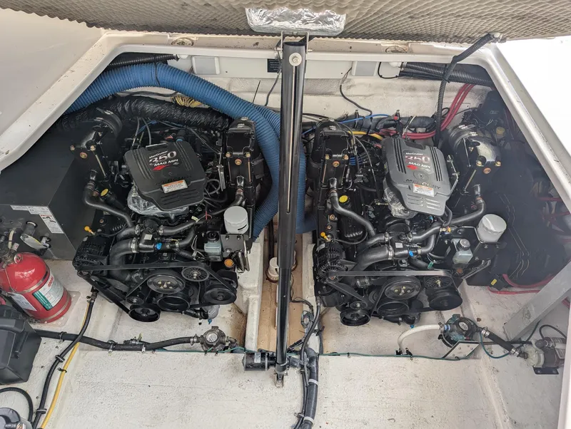 Slide: The Image of Engine compartment of a 2007 Crownline 340 CR boat, featuring dual engines and a fire extinguisher. - 26