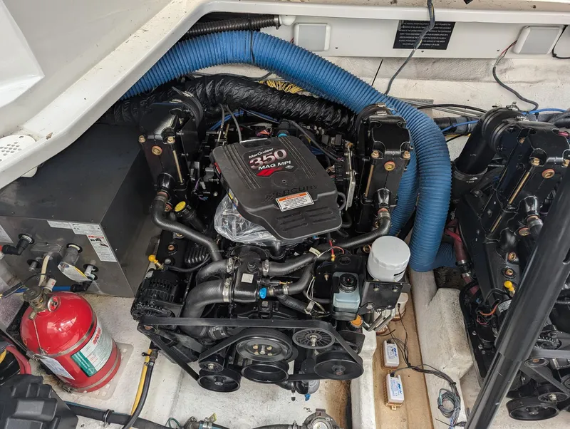 Slide: The Image of Engine compartment of a 2007 Crownline 340 CR boat, featuring a 250 horsepower engine. - 28