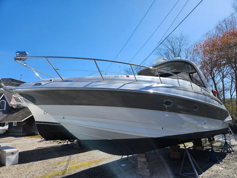 Slide: The Image of 2007 Crownline 340 CR boat on display, sleek design, parked outdoors. - 4