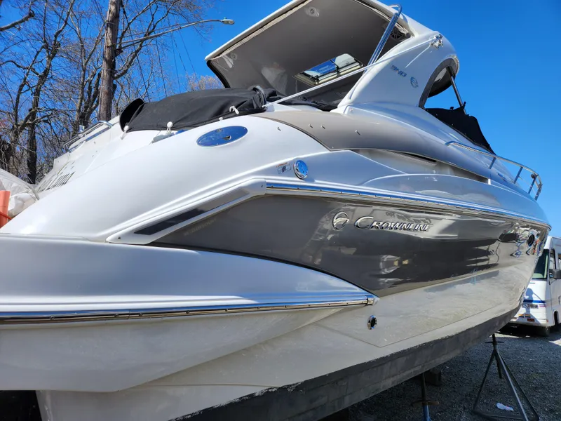 Slide: The Image of 2007 Crownline 340 CR boat, sleek design, docked outdoors under clear blue sky. - 6