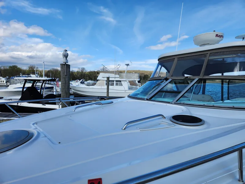 Slide: The Image of 2007 Crownline 340 CR yacht docked at marina under blue sky. - 7