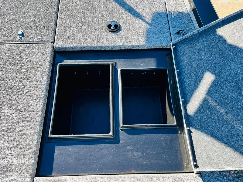 Slide: The Image of 2020 G3 Sportsman 1910 boat storage compartments with open lids. - 22