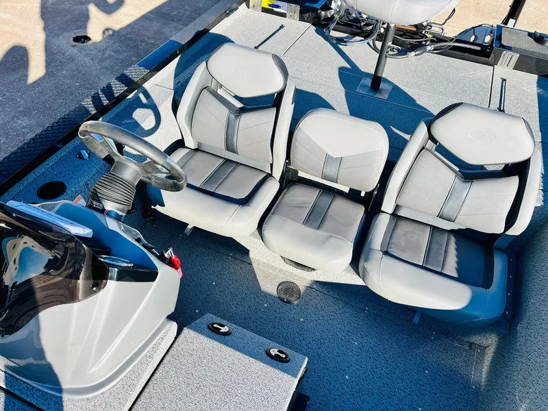 Slide: The Image of 2020 G3 Sportsman 1910 boat interior with three gray seats and steering wheel. - 27