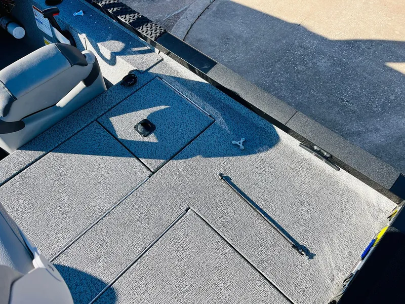 Slide: The Image of 2020 G3 Sportsman 1910 boat interior with gray carpet and seating. - 40