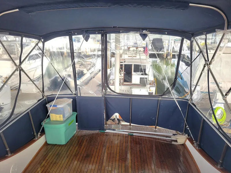 Slide: The Image of 1983 Marine Trader 34 Trawler interior with wooden flooring and covered deck. - 10