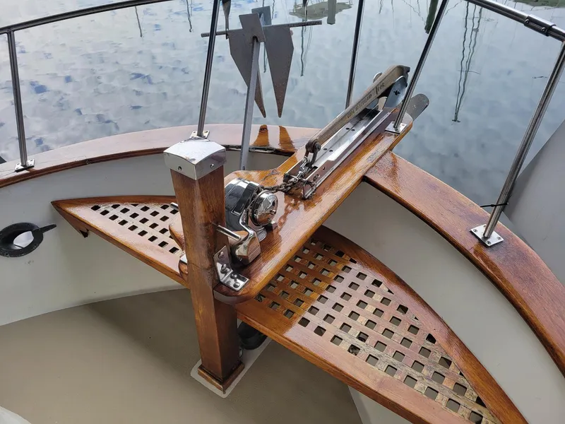 Slide: The Image of 1983 Marine Trader 34 Trawler anchor winch and bow detail with wooden deck. - 12