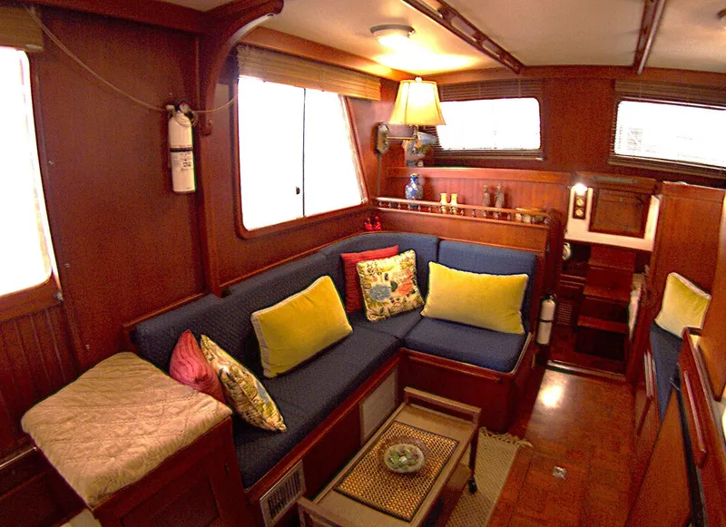Slide: The Image of Cozy interior of 1983 Marine Trader 34 Trawler with colorful cushions and wooden accents. - 14