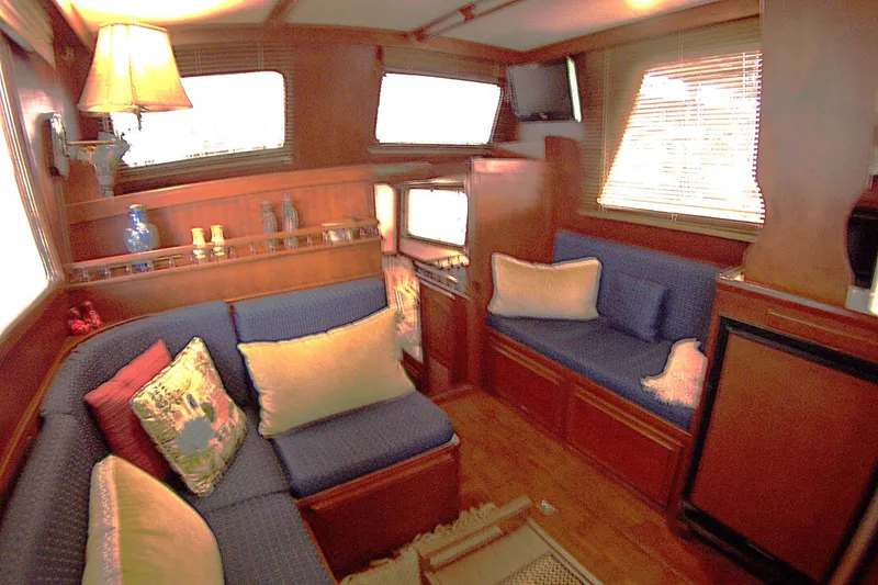 Slide: The Image of Interior of 1983 Marine Trader 34 Trawler with cozy seating and wooden accents. - 15