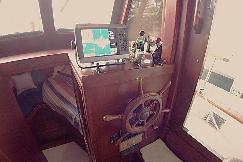 Slide: The Image of 1983 Marine Trader 34 Trawler helm with navigation equipment and cozy cabin interior. - 19