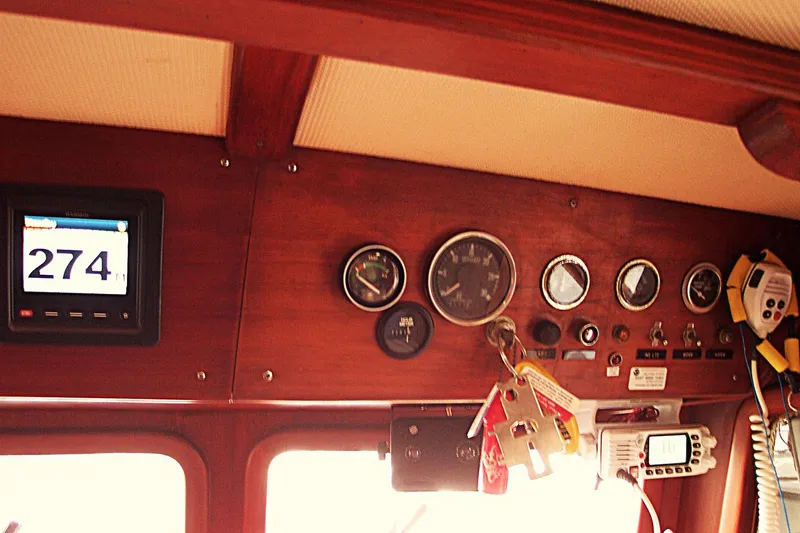 Slide: The Image of Control panel of a 1983 Marine Trader 34 Trawler with gauges and navigation equipment. - 21