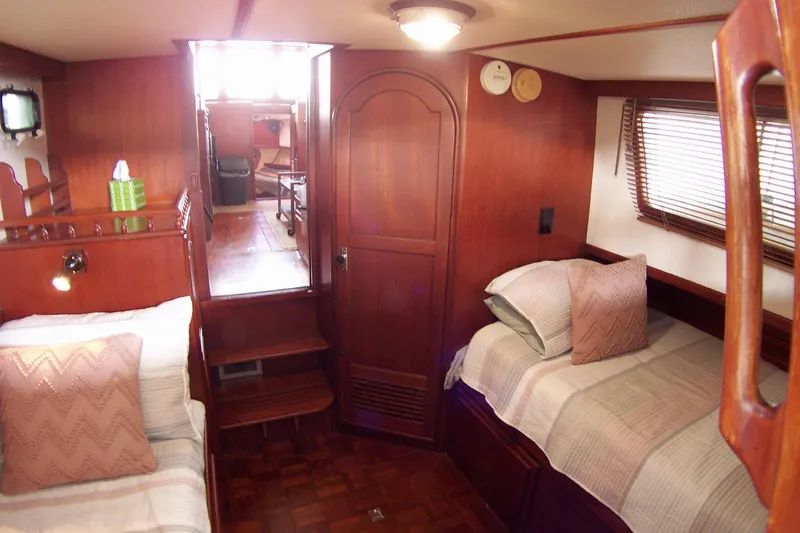 Slide: The Image of Cozy cabin interior of 1983 Marine Trader 34 Trawler with twin beds and wooden decor. - 23