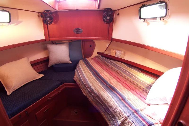 Slide: The Image of Cozy cabin interior of 1983 Marine Trader 34 Trawler with colorful bedding and pillows. - 27