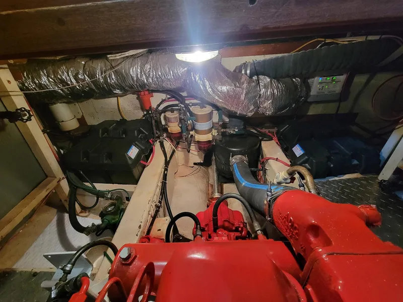 Slide: The Image of Engine room of 1983 Marine Trader 34 Trawler with visible components and wiring. - 32