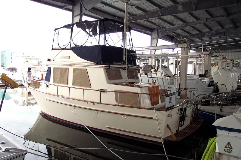 Slide: The Image of 1983 Marine Trader 34 Trawler docked in a covered marina. - 37