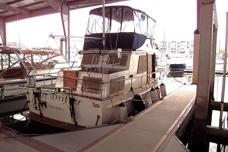 Slide: The Image of 1983 Marine Trader 34 Trawler docked in a covered marina. - 38