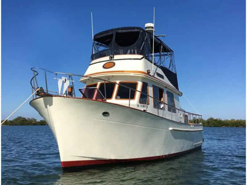 Slide: The Image of 1983 Marine Trader 34 Trawler on calm water under clear blue sky. - 5