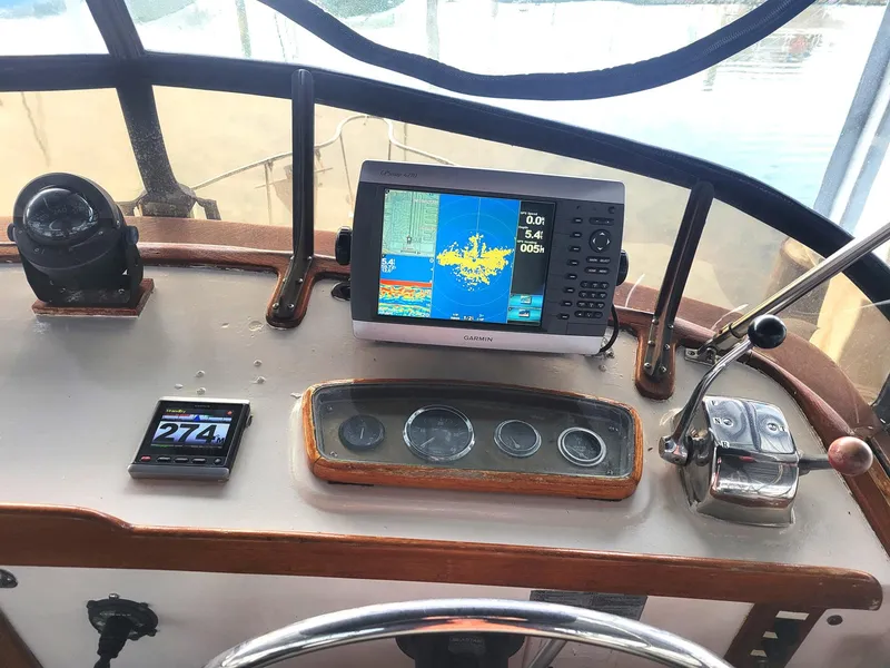 Slide: The Image of 1983 Marine Trader 34 Trawler helm with navigation equipment and controls. - 9