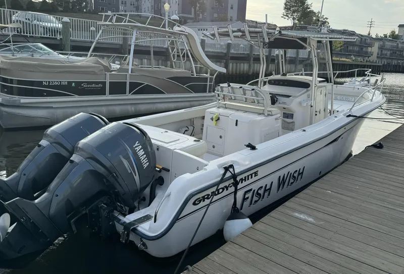 Slide: The Image of 2004 Grady-White Release 283 boat docked with twin Yamaha engines. - 2