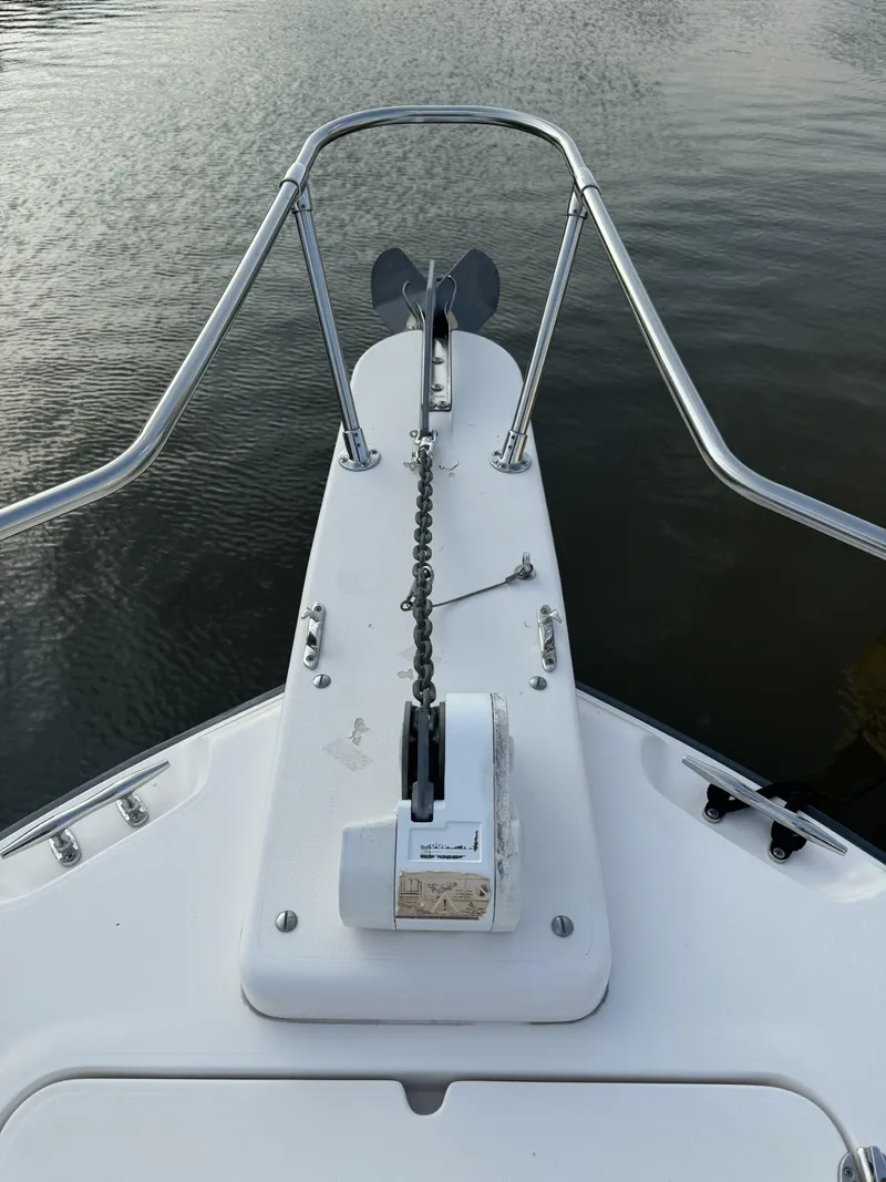 Slide: The Image of 2004 Grady-White Release 283 boat bow with anchor chain on calm water. - 5