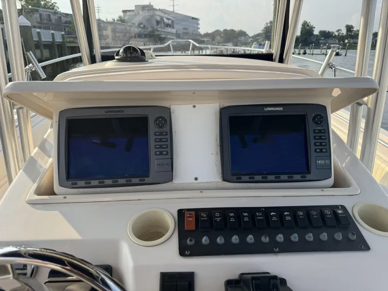 Slide: The Image of 2004 Grady-White Release 283 boat dashboard with dual Lowrance displays and control panel. - 6