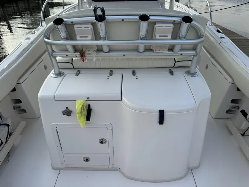 Slide: The Image of 2004 Grady-White Release 283 boat interior with rod holders and storage compartments. - 8