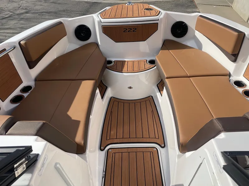 Slide: The Image of 2025 Yamaha Boats 222SD interior with brown seating and wood accents. - 11