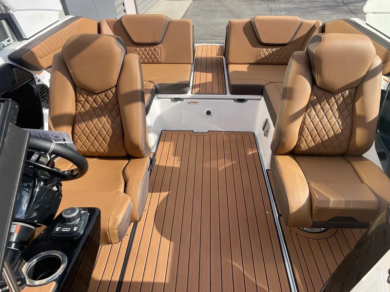 Slide: The Image of 2025 Yamaha Boats 222SD interior with luxurious brown leather seating and sleek design. - 12